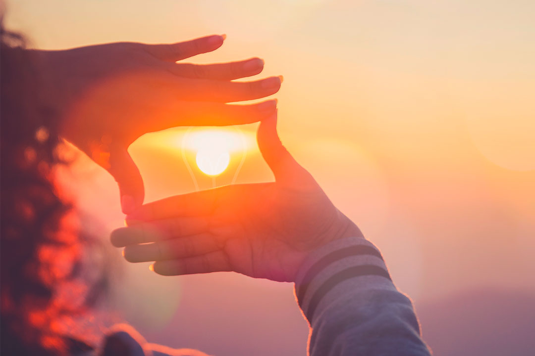 Hände umrahmen Lichtquelle Sonne